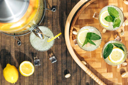 jar of home-made lemonade pour drink into glass, flat layの写真素材