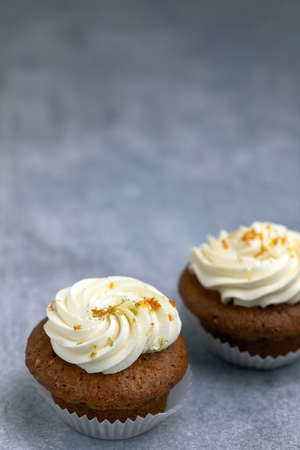 carrot cupcakes with a cream cap on a gray backgroundの写真素材