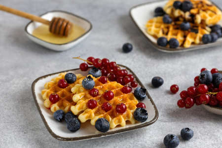 breakfast served - waffles with berries and honeyの写真素材