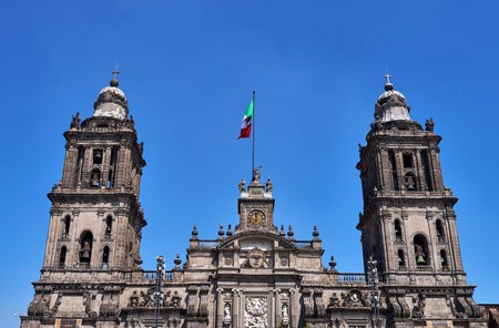 Towers of the Mexico City Metropolitan Cathedral with Mexican flag waving in the centerの写真素材