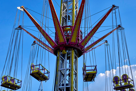 Empty flying swings in fairground close-upの写真素材