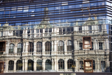 The Chambre de Commerce building in Lyon reflected in the window panes of the Grand Bazar building のeditorial素材