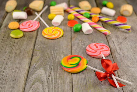  Lollipops with sweet things on the wooden table