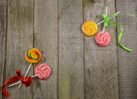 Border with lollipops on wooden background, with copy spaceの写真素材