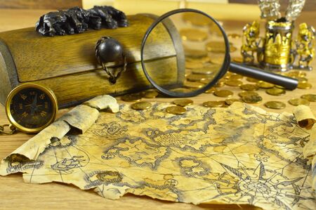 Wooden box with compass, magnifying glass and old mapの写真素材