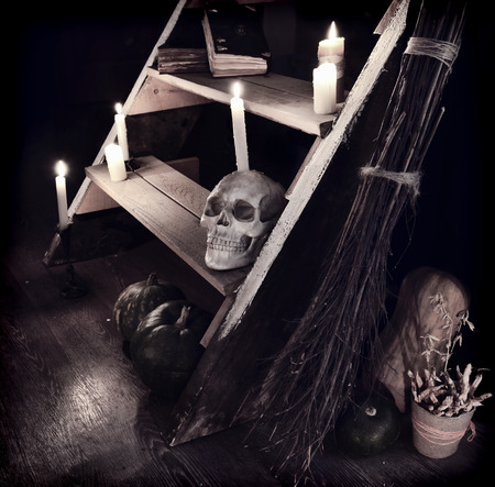 Scary mystic ritual with human skull, candles and evil staircase in witch house. Occult or esoteric still life with magic objects, Halloween backgroundの写真素材