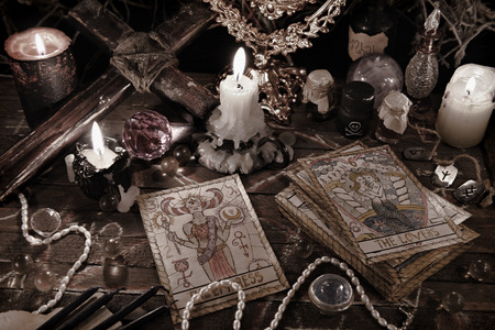 Mystic ritual with tarot cards, vintage objects and candles in grunge style. Halloween concept,...