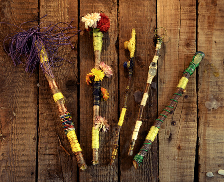 Colorful hand made decorated magic wands on witch table, top view. Occult, esoteric, divination and wicca concept. Halloween vintage backgroundの写真素材
