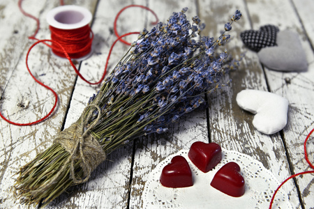 Lavender flowers bouquet, red heart chocolate candies, love symbols and decorations. Romantic vintage valentineâs day and wedding backgroundの写真素材