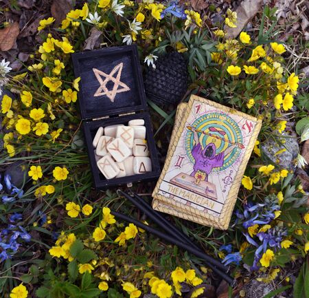 Witch runes, black candles and tarot cards. Wicca, esoteric, divination and occult concept with...