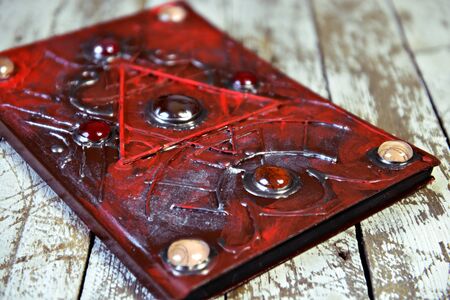 Magic book on witch workshop table. Esoteric, gothic and occult concept, Halloween mystic...