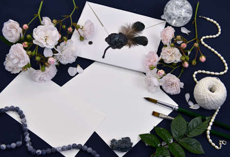 Still life with decorated envelope, paper sheets, roses and crystal on table. Mystic and romantic background with copy space and blank, vintage romantic concept for mock up, top viewの写真素材