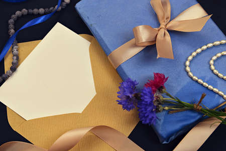 Decorated book with lace and bow, envelope with paper sheet on table. Mystic and romantic background with copy space and blank, vintage romantic concept for mock up, top viewの写真素材