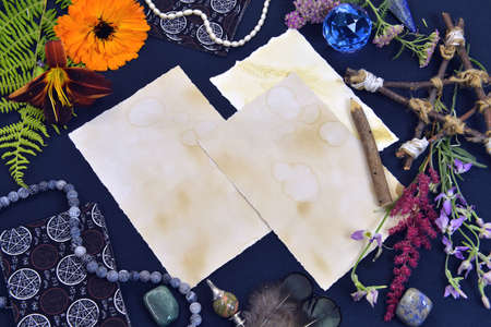 Mystic still life with old paper with copy space, tarot cards and pentagram on witch table....