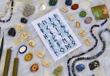 Still life with runes, chakras symbols on stones and ritual objects.  Esoteric, gothic and occult background, Halloween mystic concept.の写真素材