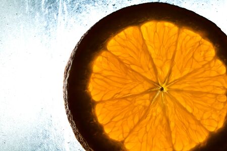 Cutted orange on wet surfaceの写真素材