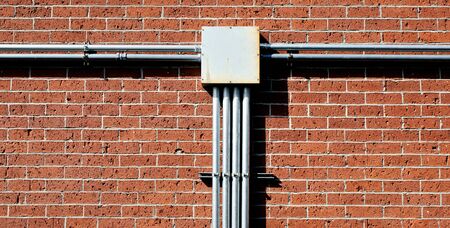 electrical junction box on red brick wallの写真素材