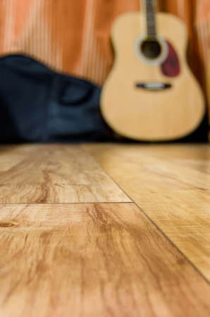 acoustic quitar in a room with wooden floorの写真素材