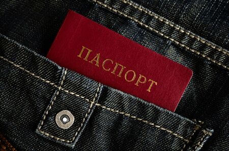 red Ukrainian passport in pocket of black jeansの写真素材