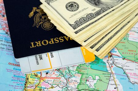 Passport book and tickets on a map and moneyの写真素材