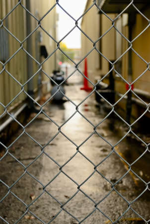 Fence and blurry by-street on the backgroundの写真素材