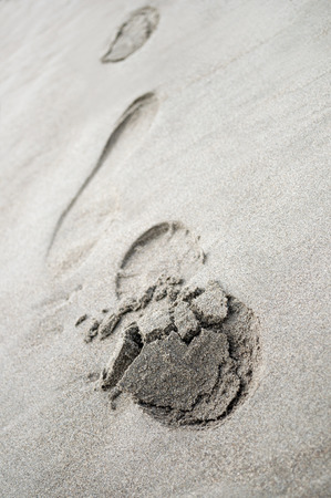 footprints close-up on the beach sand, cloudy dayの写真素材