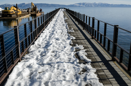 View of partly covered pier with snow, Lake Tahoeの写真素材