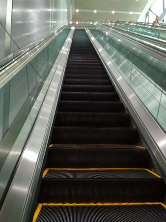 Metallic escalator moving upwardsの写真素材
