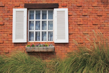 White window on brick wall of vintage house styleの写真素材