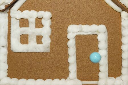 Christmas handmade brown gingerbread house. Sweet wall with white sugar window and door. Closeupの写真素材