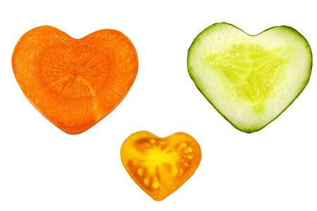 Carrot, cucumber and tomato isolated on white background. Heart shape vegetablesの写真素材