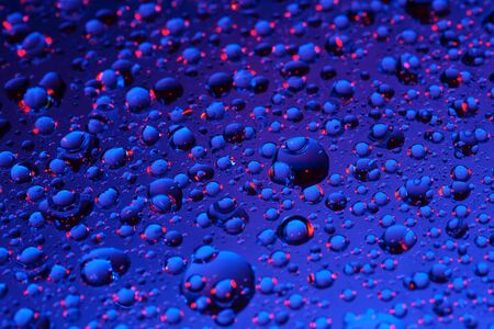 Dark blue background with water dropsの写真素材