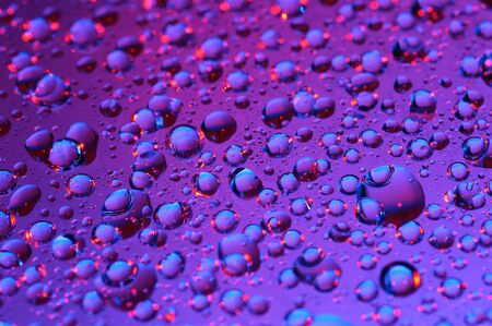 Violet background with water dropsの写真素材