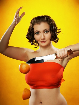 The girl with a knife and an orangeの写真素材
