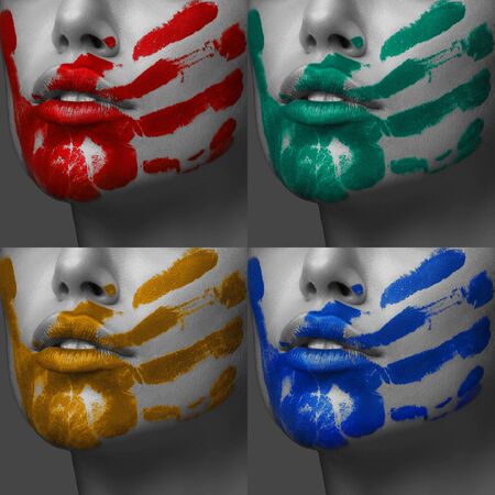colorful hand prints on her face with perfect skin black and white with an accent orange red blue and jadeの写真素材