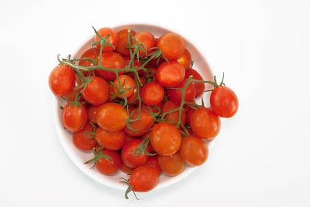 cherry tomatoes s in bowl, isolated on white background. Top viewの写真素材