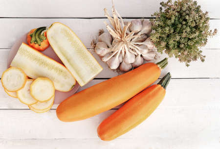 Two bright gold-yellow zucchini squash on the wooden and rustic background. Healthy vegetable. Season autumn food. Simple composition shot top view. aboveの写真素材