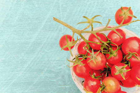 cherry tomatoes on wooden background. Rustic style. Outdoorの写真素材