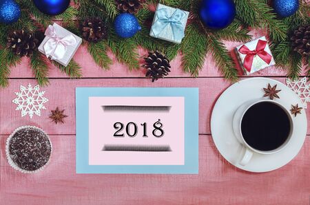 Christmas background with decorations  evergreen branches of fir, blue ball, bauble, pine cones on the pink wooden table. Copy space for holiday text or greeting. Lovely  xmas card. Food. Planingの写真素材