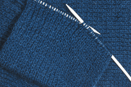 Blue knitting wool and needles. English elastic yarn. Top view