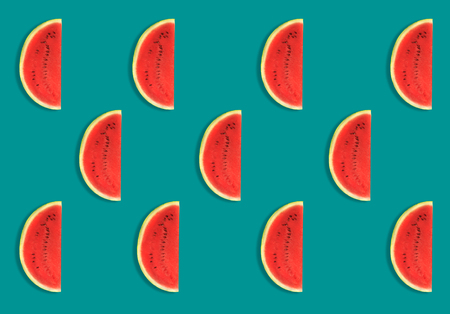 Colorful fruit pattern of fresh watermelon slices on blue background. From top view