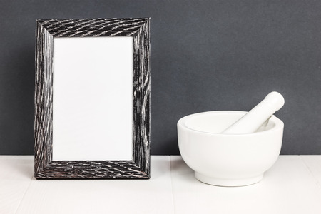 Mortar.  White tableware on table.  Ceramic stiff. Picture frame copy spaceの写真素材