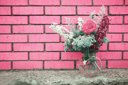 Beautiful bouquet of flowers on a background of bright pink brick wall. Copy space for textの写真素材
