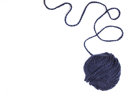 Balls of wool soft yarn with needle for knit on the white wooden background. Copy space for text