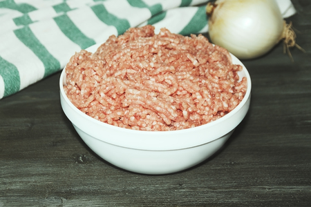 Bowl with fresh forcemeat on the green wooden tableの写真素材