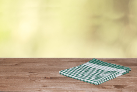 Empty wooden deck table with tablecloth for product montage. Free space for your textの写真素材