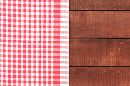 Wooden table and red tablecloth or napkin. Retro background with tablecloth. Top viewの写真素材
