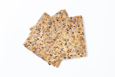 Crispy bread with seeds of sunflower, flax and sesame seeds Isolated on white background