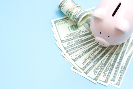 Piggy bank money on blue background. Savings conceptの写真素材