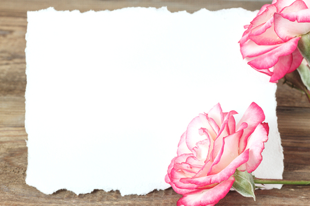 Present or gift box in craft paper with pink ribbon bow on wooden table. Greeting card for Valentine or Mother Day.の写真素材